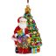 Collectible glass tree ornament Santa next to the tree